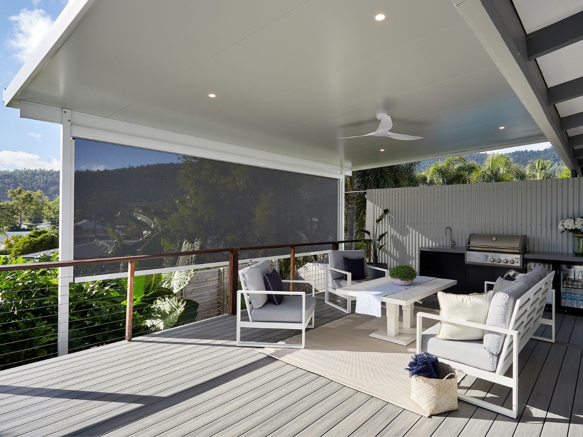 Ziplock outdoor blind on a modern covered deck with outdoor seating and mountain views, offering sun protection and privacy.