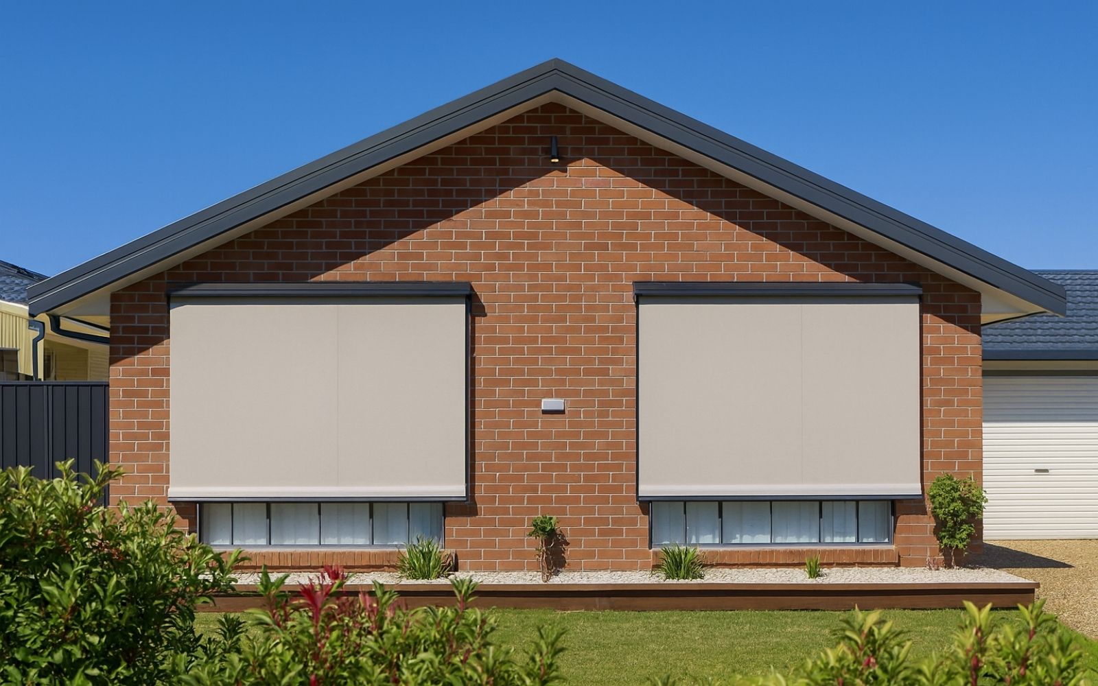 Outdoor window shade blinds on a modern Australian brick home, blocking harsh sunlight and reducing heat.