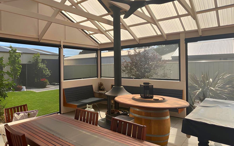 Side-retained outdoor blinds enclosing an alfresco area