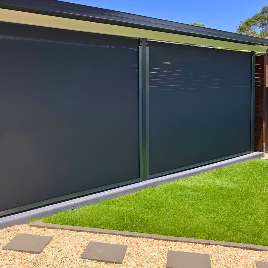 HD Channel outdoor blind tensioned within side tracks beside a lawn
