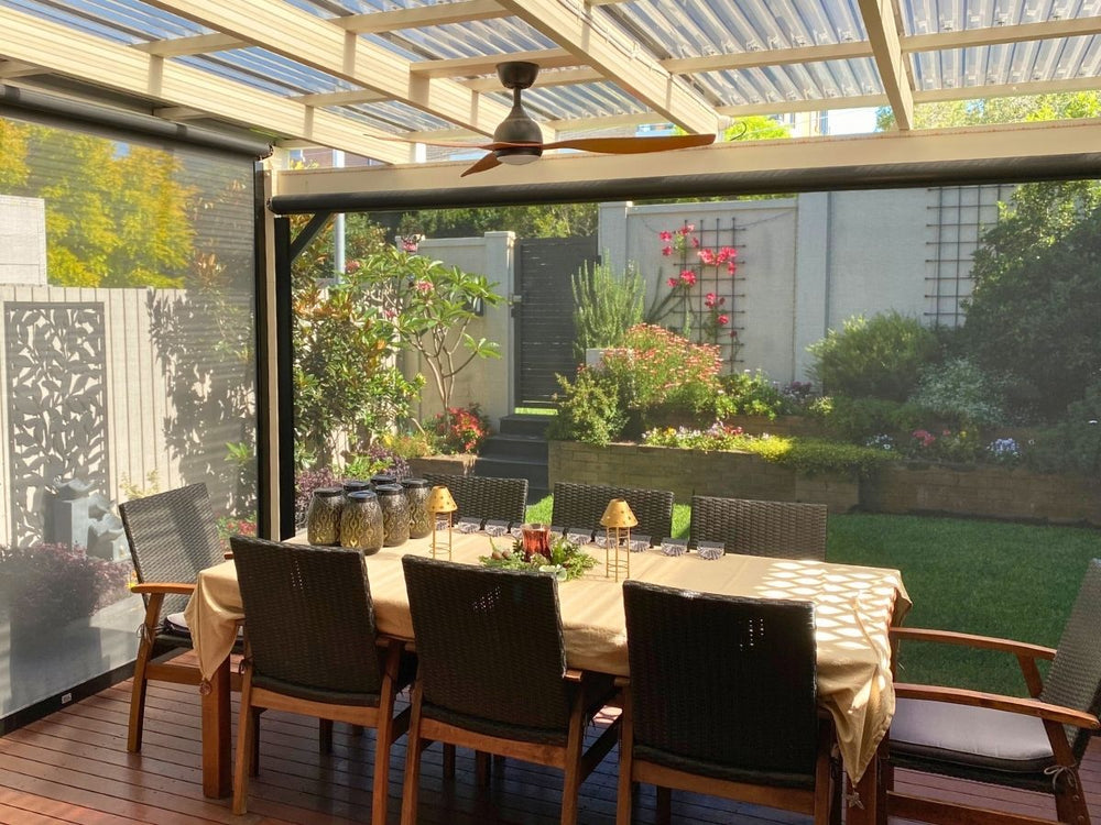 Outdoor blinds protecting an alfresco dining area from weather