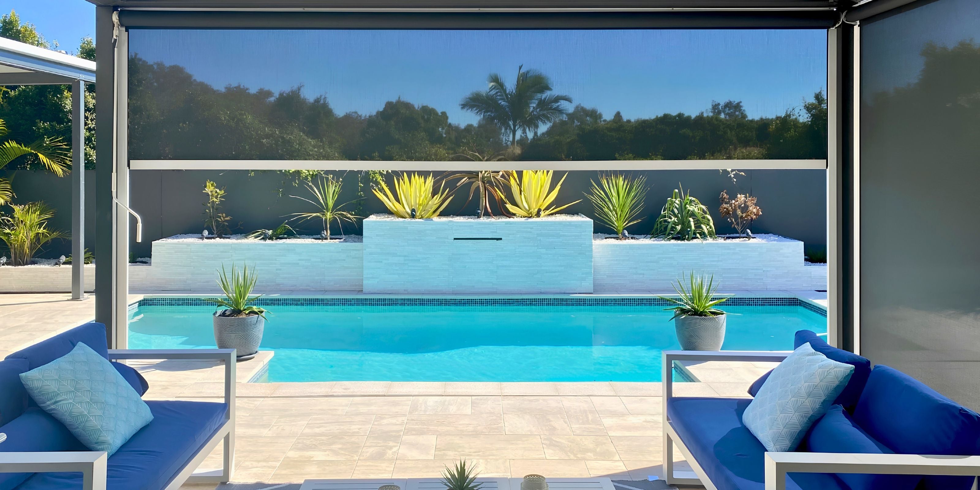 Custom DIY Ziplock side retention outdoor blind enclosing a luxury patio and outdoor room next to a pool.